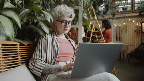 girl working on laptop in flower shop