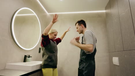 happy couple celebrating bathroom renovation