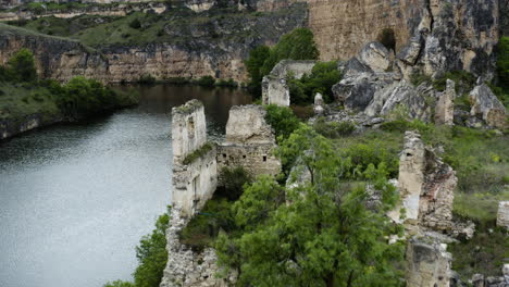 church ruins at the riverbank of duraton river in hoces del rio duraton national park in spain