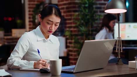 worker sulking in office, having frown on face, feeling annoyed by too much work