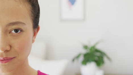 Portrait-of-happy-asian-woman-smiling-in-bedroom,-with-copy-space,-in-slow-motion