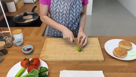 woman preparing ingredients for a burger