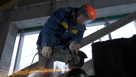 construction worker cutting concrete block