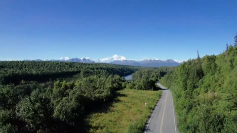 aerial view of alaskan road and bridge with denali mountain