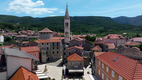 bell tower of parish of the assumption of mary in jelsa town, hvar island, croatia. - aerial shot