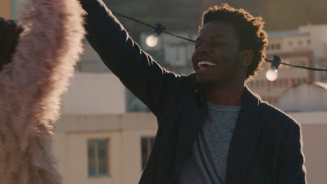 happy-young-multiracial-couple-dancing-on-rooftop-at-sunset-celebrating-relationship-having-fun-enjoying-playful-dance-together