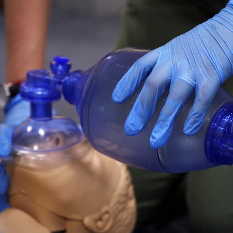 cardiopulmonary resuscitation. training demonstration of a chest compression and breathing on a dummy. close-up.