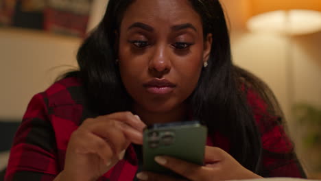 woman using a smartphone in bed at night