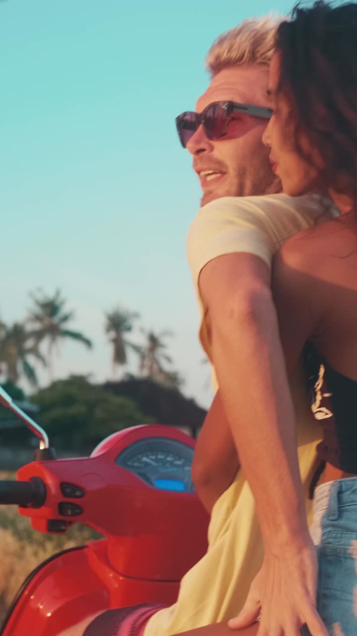 Couple enjoys tropical vacation riding a scooter