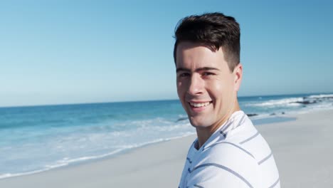 man standing on the beach and looking at camera