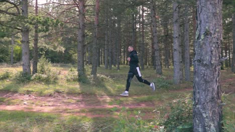 person running in a forest with tall trees