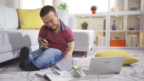 Young-male-student-with-dwarfism-studying-at-home-and-enjoying-himself.