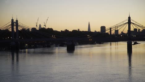 london thames north bank dawn skyline through albert bridge from battersea bridge 4k