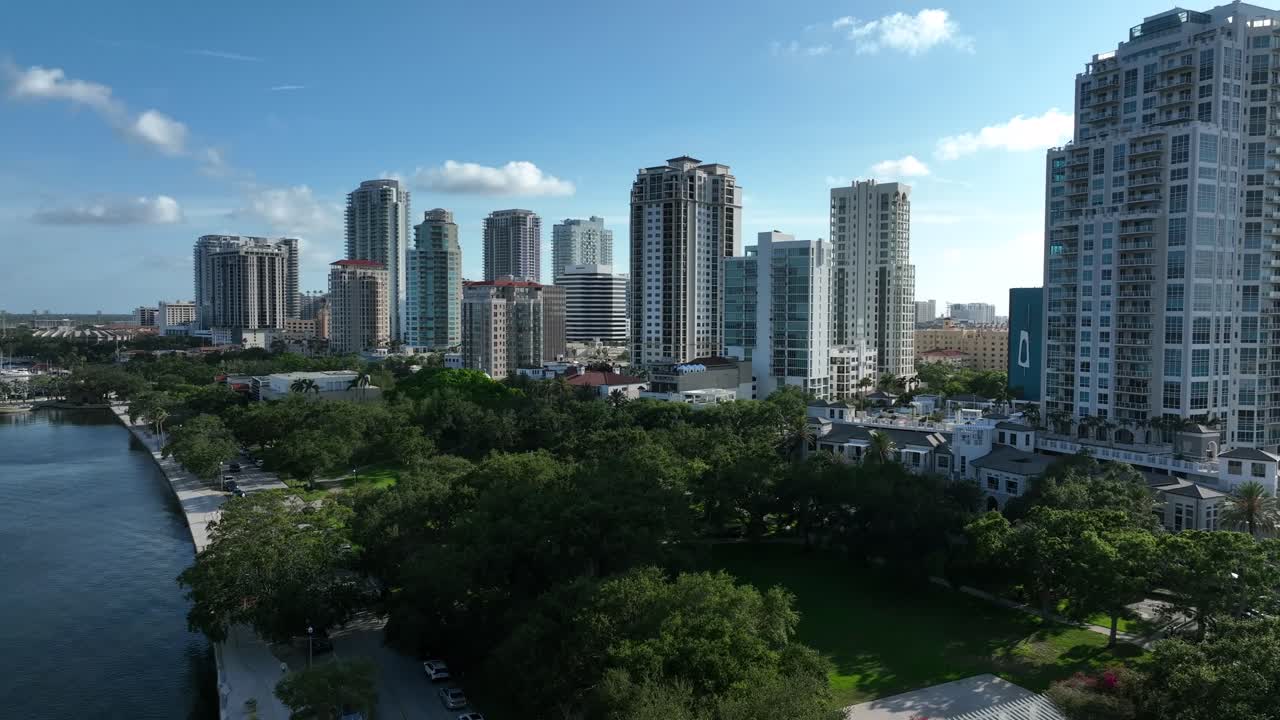 North Yacht Basin with park in front of skyline in Saint Petersburg, Florida. Aerial wide shot. Sunny day with blue sky in summer. American town with skyscrapers in cityscape. FL, United States.
