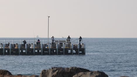 people fishing on a pier in melbourne