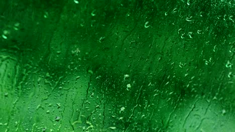 rain drops motion water green glass background