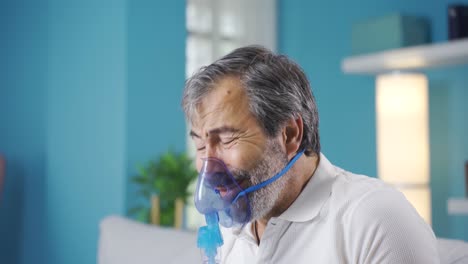 man with lung disease having difficulty breathing. connected to respirator.