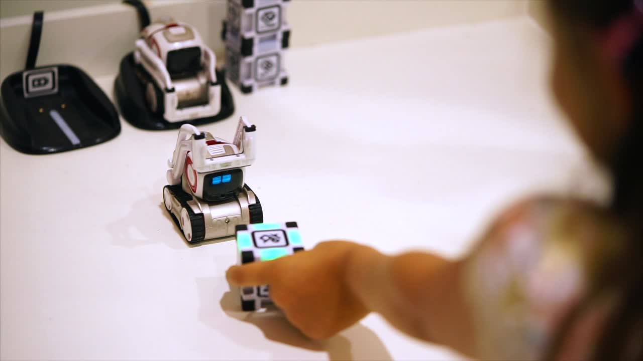 Child Playing with Educational Robot Toys