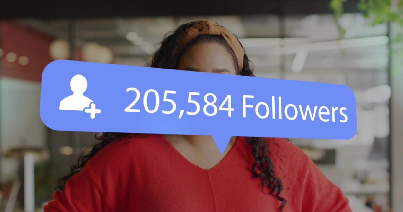 Woman standing in office watching overlay appearing rising follower counts for social media growth