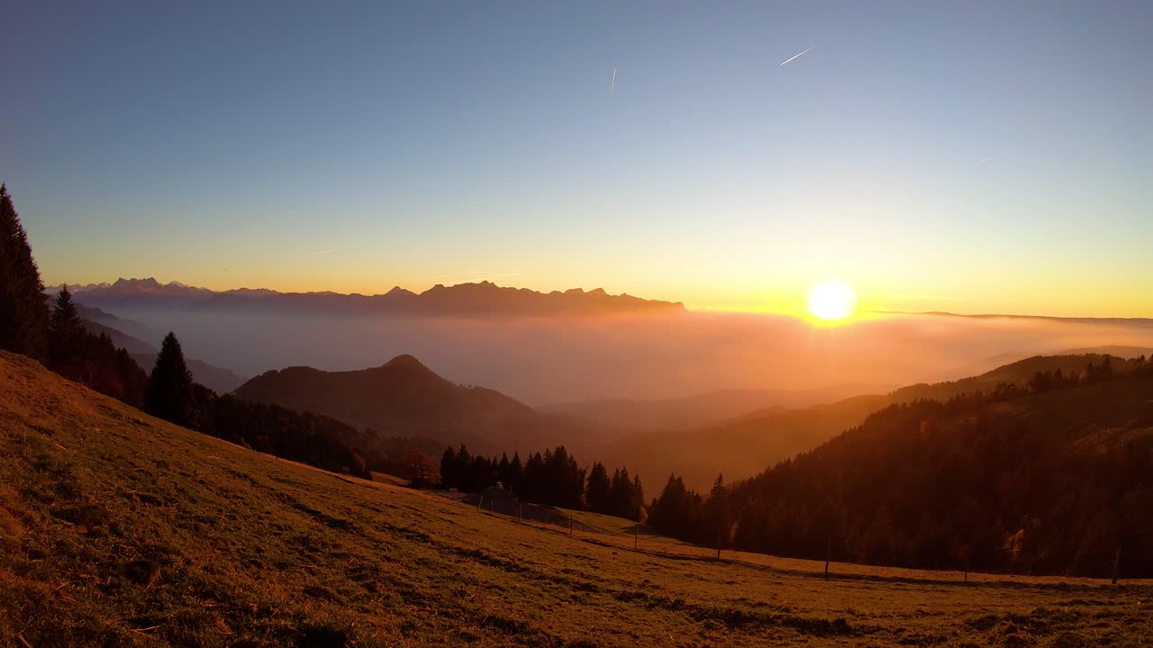 lapso de tiempo de la puesta de sol sobre la niebla que cubre el lago léman - suiza
