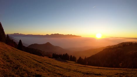 timelapse of the sun setting over mist covering lake léman - switzerland