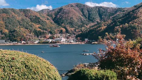 autumn scenery by the lake with boats and mountains