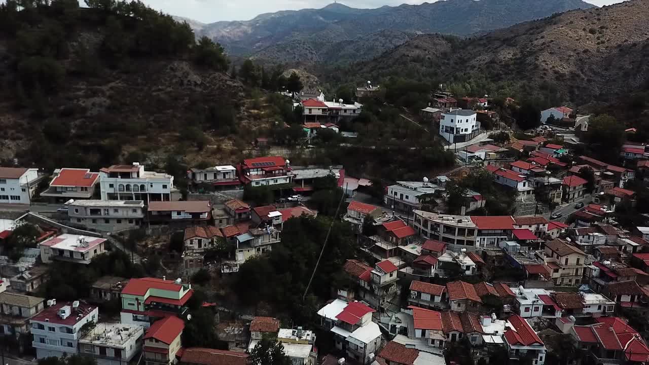 Houses On The Mountainside Village Of Paleochori Village In Greece. - aerial pullback shot