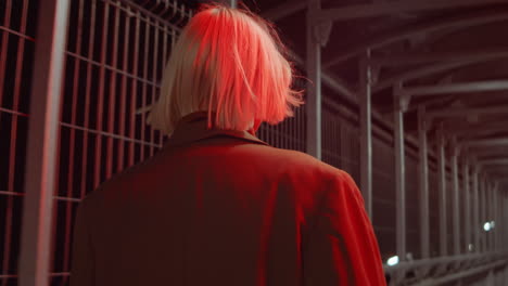 woman walking inside of pedestrian bridge in night