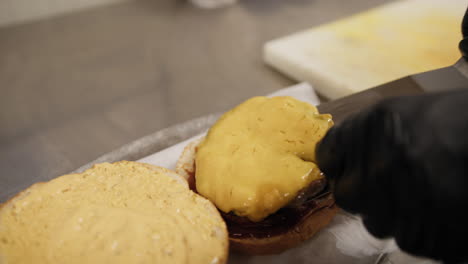 chef putting meat in the burger during preparation in the kitchen