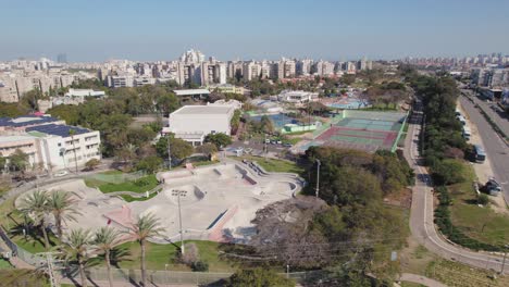 big skate park with grass and trees around - parallax shot