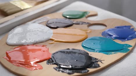 the artist prepares the paints for writing the nartina an artist works on an abstract oil painting - the artist prepares the paints for writing the nartina. an artist works on an abstract oil painting in a workshop. the concept of painting a picture