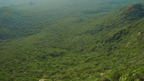 In-this-shot-you-can-see-brave-man-standing-on-steep-cliff-and-throwing-stone-to-the-horizon