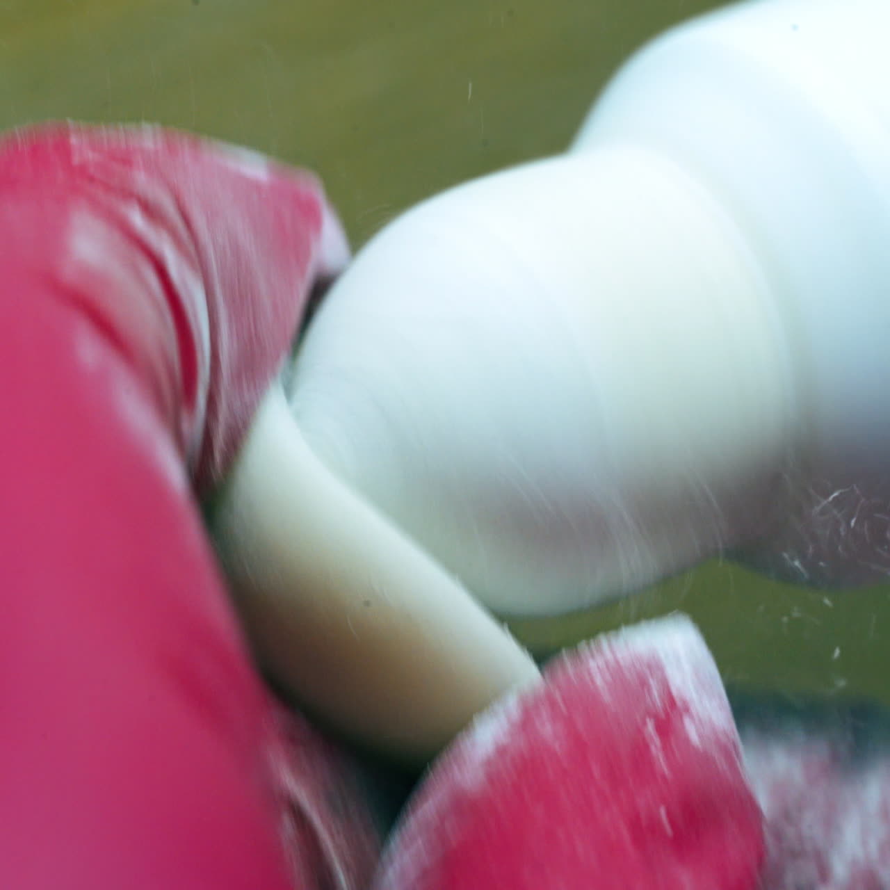 Close-up process of making eye prosthesis. Polishing plastic artificial eye by a technician.