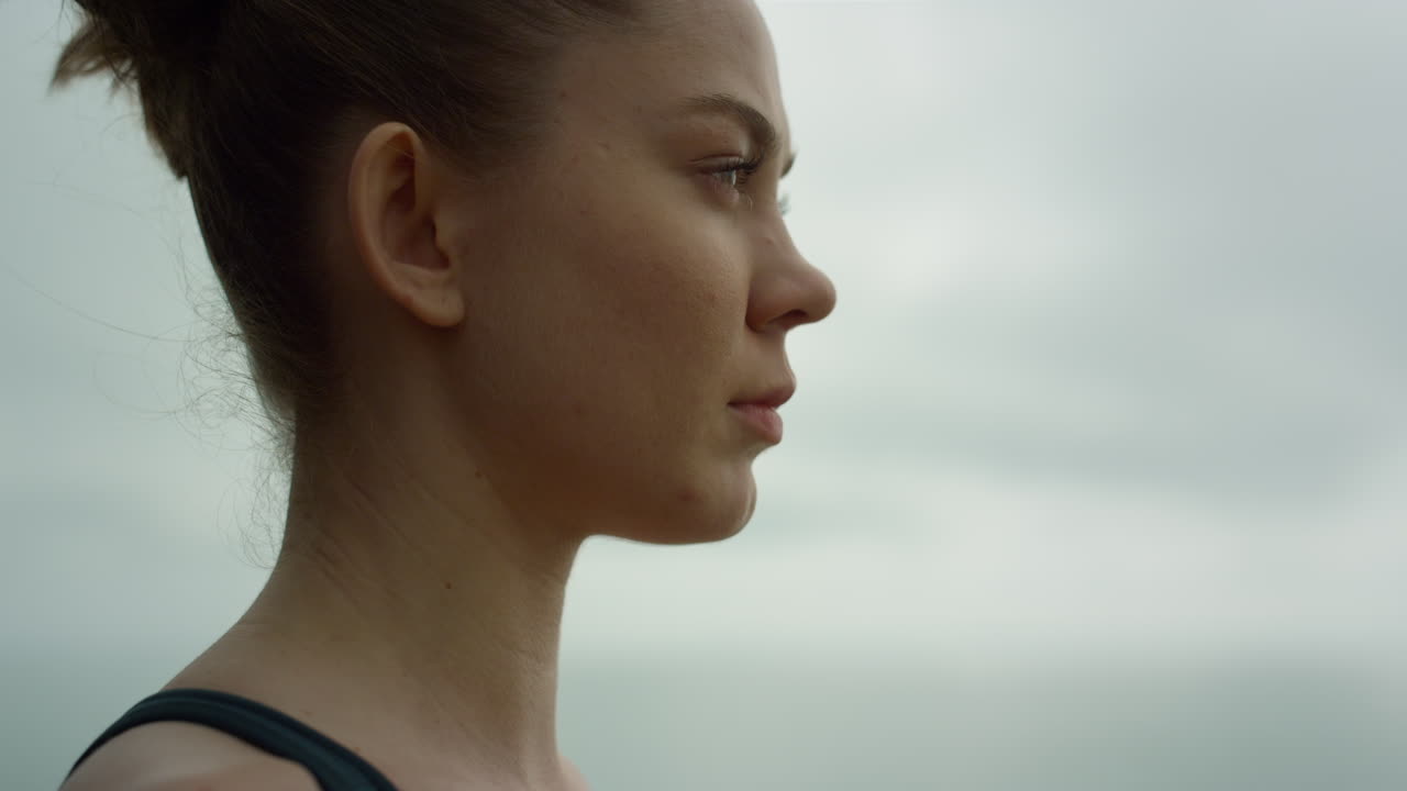 una chica hermosa haciendo ejercicios de respiración al aire libre, una deportista meditando yoga.