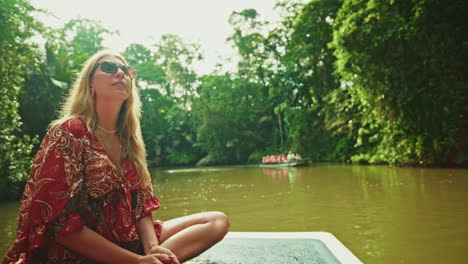 close up shot of young female traveler enjoying the green lush vegetation of tortuguero national park in costa rica.