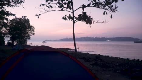 beautiful sunrise at the campsite of pulau ubin in singapore - wide shot