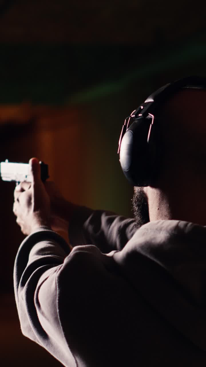 Vertical video Gun enthusiast reloading handgun, pointing weapon