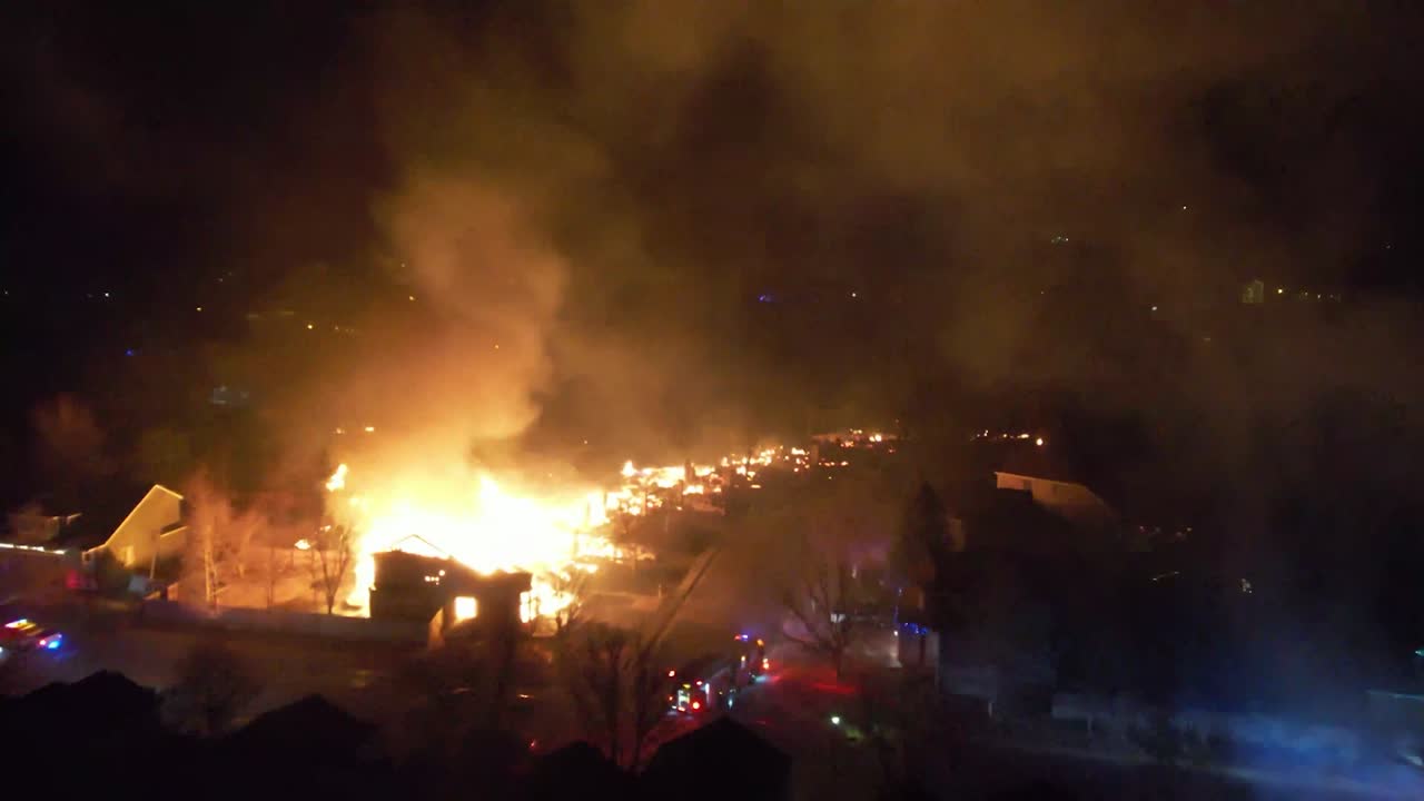 DRONE OF RESIDENTIAL NEIGHBORHOOD ON FIRE AT NIGHT