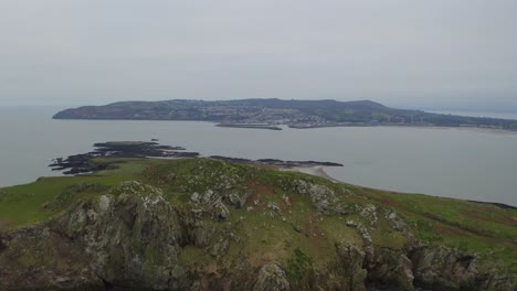 Cinematic-tracking-shot-showcases-Ireland's-Eye-cliffs,-flying-over