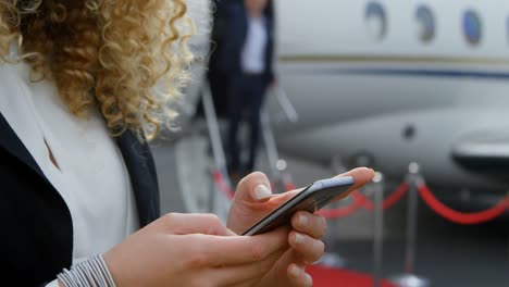Businesswoman-using-mobile-phone-at-terminal-4k