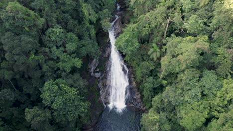 drone flying towards a waterfall