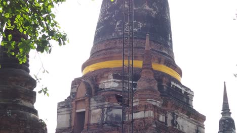 person climbs ancient stupa, reaches the top