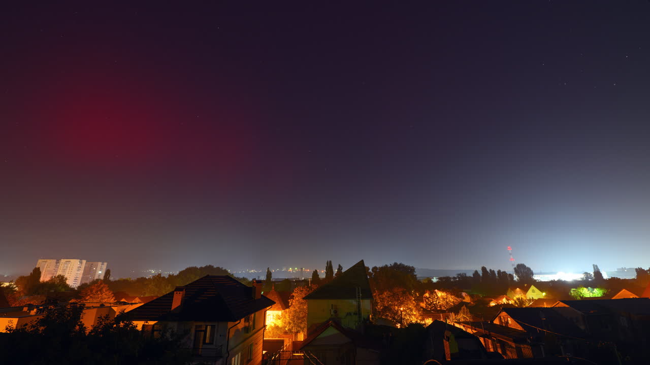 Timelapse of red traces of Aurora Borealis northern lights above Chisinau, Moldova