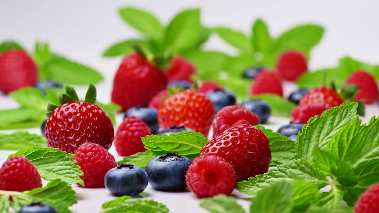 Fresh Raspberries Blueberries And Mint, Scattered Mint Leaves With Ripe Raspberries And Blueberries On Clean