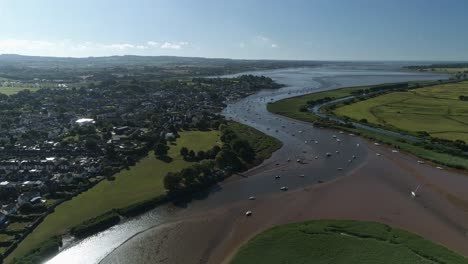 aerial of the village of topsham in the shade on a sunny morning