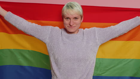 woman with short hair with rainbow lgbt flag celebrate parade show tolerance same sex marriages