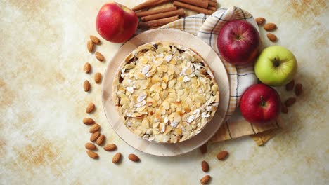 Freshly-baked-homemade-apple-pie-with-almond-flakes-cake-on-yellow