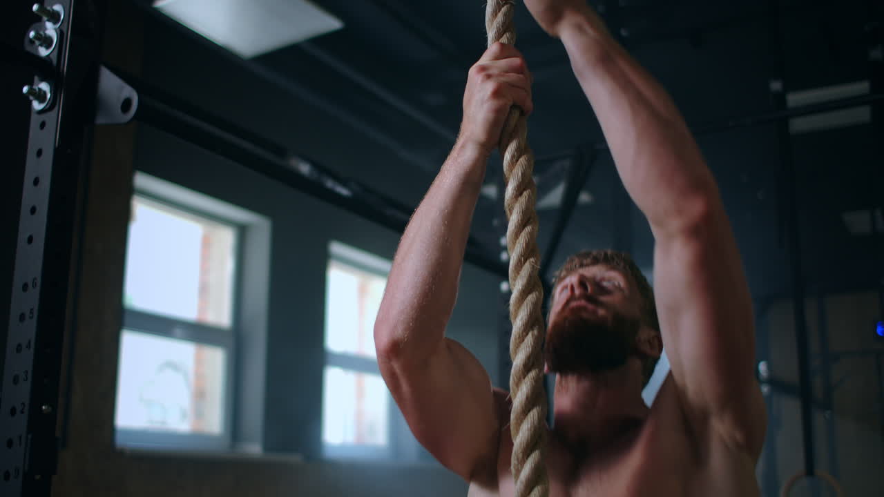 훈련 중 강한 남자들은 로프를 타고 꼭대기까지 올라갑니다. 구조자의 훈련. 지구력과 조정에 대한 운동.