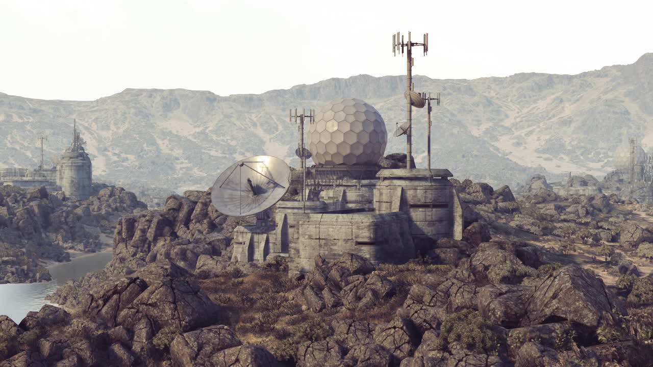 Remote communication station situated among rocky landscape with mountains