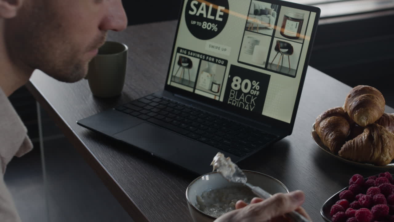 Laptop displaying online sale advertisement with food on the side